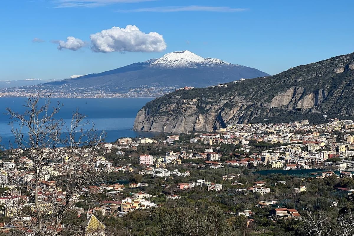 A coastal town with a mountain in the background.