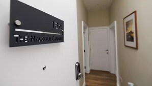 A hallway with a door labeled "15c THE MALCOLM CANMORE". - Stylish 1-bed Apartment in the Heritage Quarter (Dunfermline)