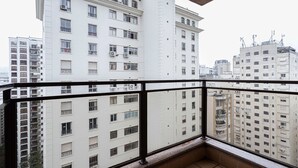 A high-rise building with multiple balconies and windows.