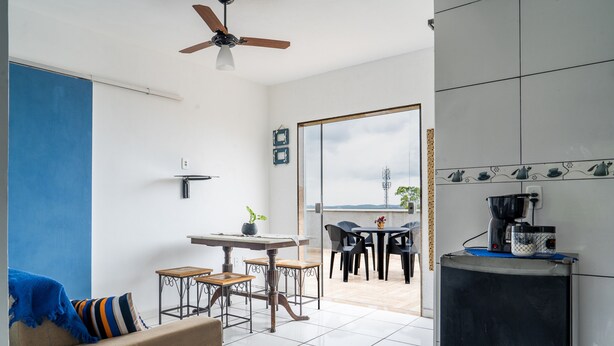 A compact living space with a kitchenette, a dining area, and a seating area.