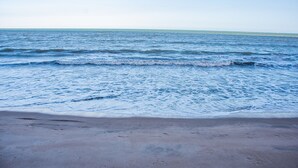 A beach with waves approaching the shore. - Suite Recanto dos Macacos - Quarto 2 (Prado)