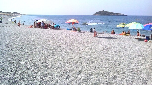 A pebble beach with umbrellas and people. - TRIVANO PARCO ULIVI SECONDO PIANO (Cirella)