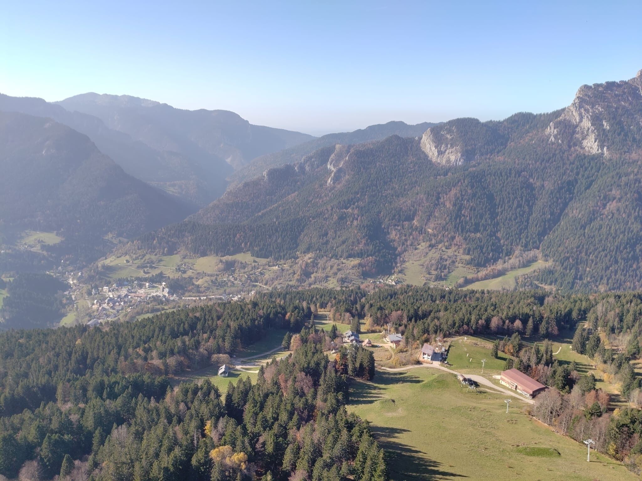 A mountainous landscape with a small village nestled in a valley.