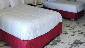 A hotel room with two beds, a nightstand with a lamp, a mirror, and marble-patterned flooring. - Super Inn Motel (Oklahoma City)