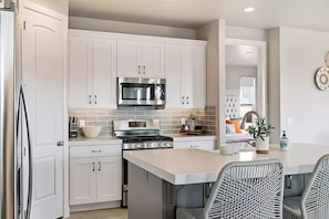 Enjoy cooking in this well-lit kitchen with a large island and oven.