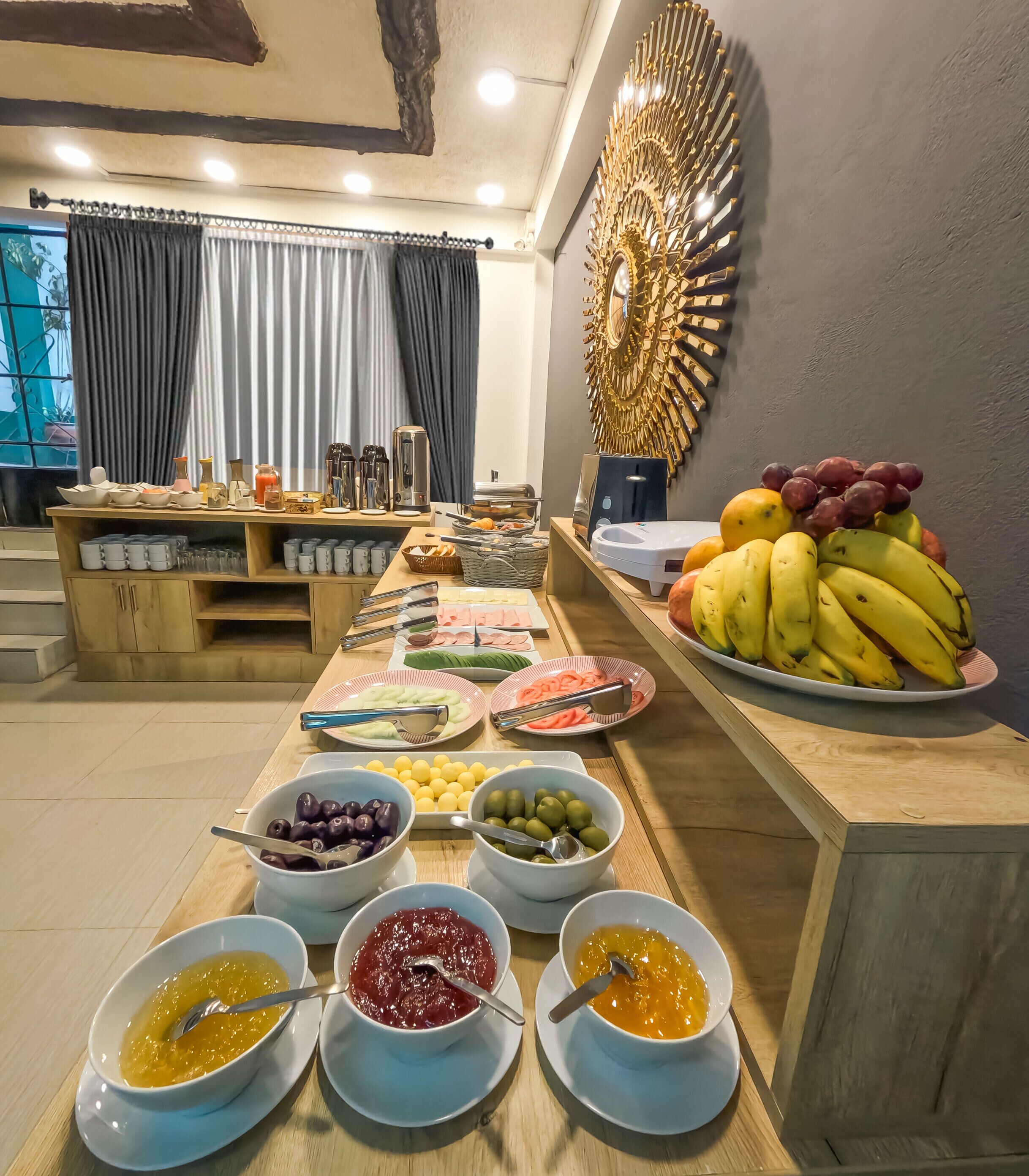 A buffet setup with various food items and utensils.