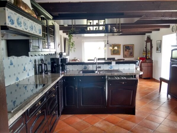 Enjoy cooking in this well-equipped kitchen with a central island, sink, and dishwasher.