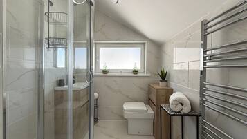 Shower, hair dryer, towels, toilet paper