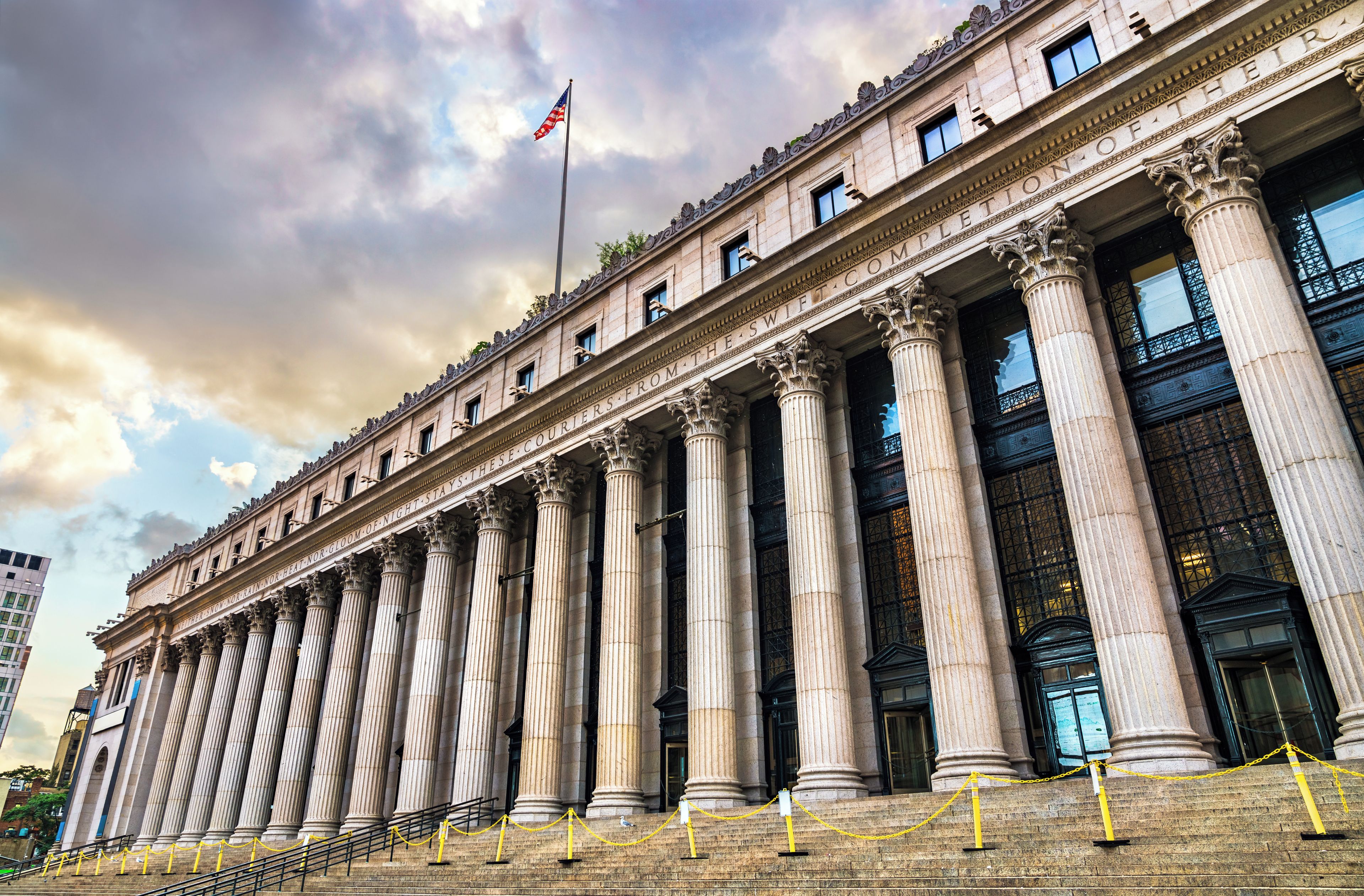 A large building with multiple columns and a flag.
