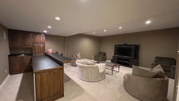 A home interior with a kitchen, living room, and entertainment area. - Get cozy in this 2-bedroom garden apartment in peaceful Alpharetta. (Alpharetta)