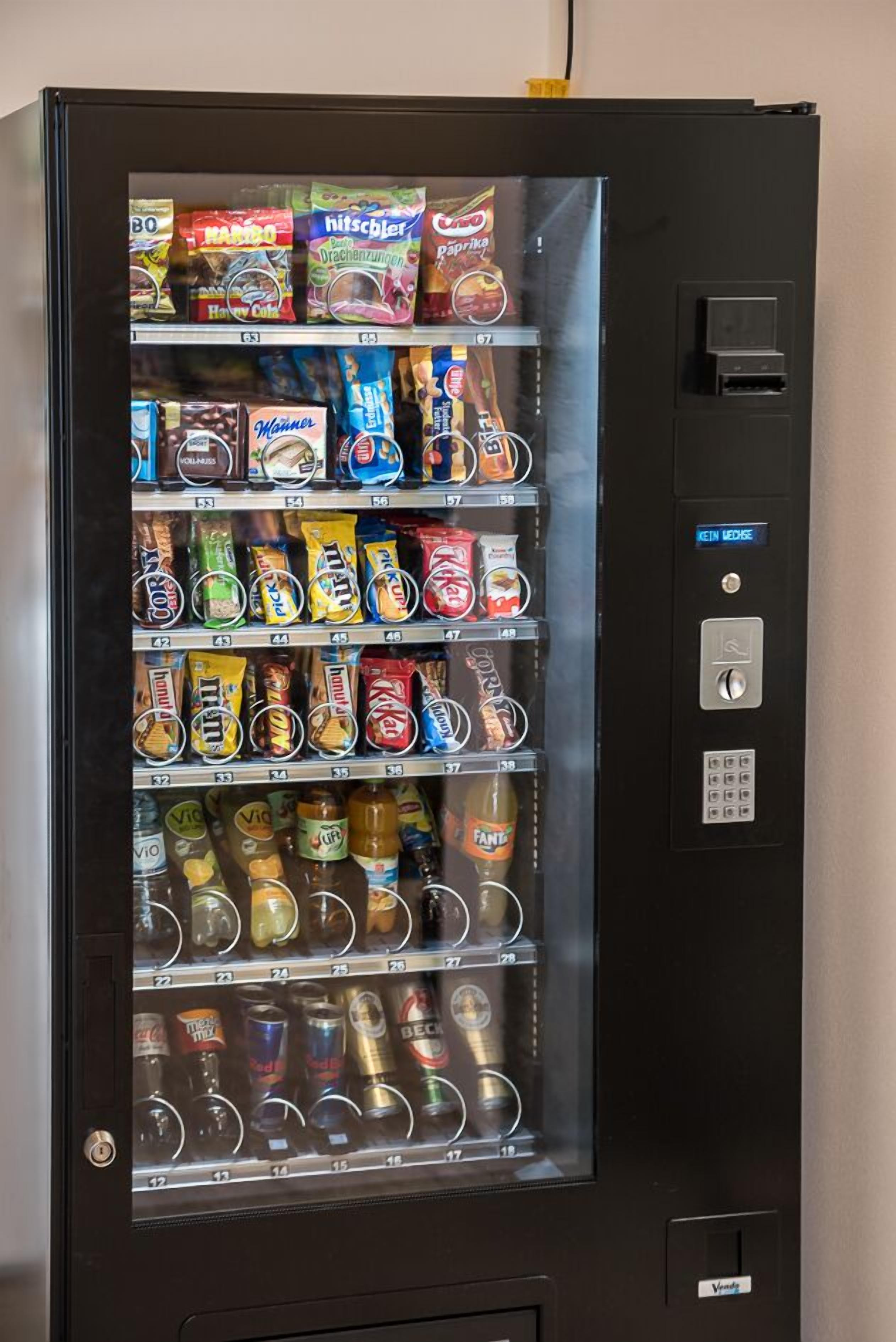 A vending machine stocked with snacks, drinks, and other items.