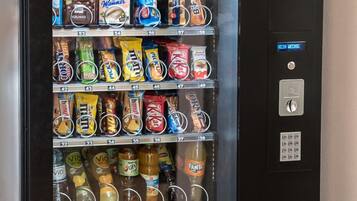 A vending machine stocked with snacks, drinks, and other items.