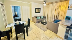 A modern living room with a dining area, a sofa, and a coffee table. - Beautiful private apartment Ecovivienda Etapa 1 (8 minutes American Embassy) (Tegucigalpa)