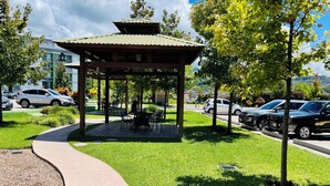 A gazebo with a tiled roof, surrounded by a grassy area with a curved walkway. - Beautiful private apartment Ecovivienda Etapa 1 (8 minutes American Embassy) (Tegucigalpa)