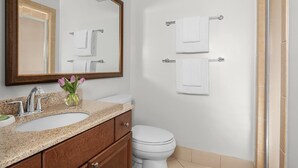 A bathroom with a sink, mirror, and two towels on hooks. - Marriott's Harbour Point - Hilton Head Island
2 Bedroom Villa (Hilton Head Island)