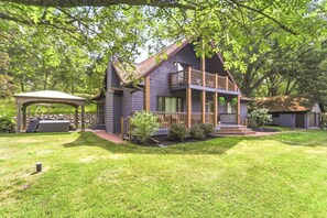 A two-story house with a covered porch and a fenced yard.