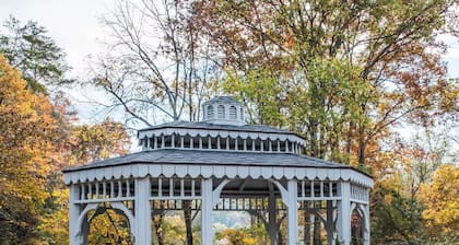 Spacious 4-bedroom farmhouse with 20 acres surrounded by a whitewater creek.