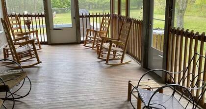 Spacious 4-bedroom farmhouse with 20 acres surrounded by a whitewater creek.