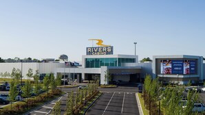 A Rivers Casino building with a prominent sign, a parking lot, and a water tower in the background. - Beautiful, modern furnished 3-bedroom, 2-bathroom cottage near attractions. (Portsmouth)