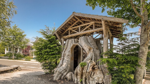 A rustic wooden structure with a natural tree trunk base, a covered entrance, and a gravel path leading to it. - Arcade, Family + Dog Friendly, Seabrook Town Center Home, 5min. walk to beach (Pacific Beach)
