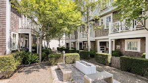 A courtyard with a gravel path, benches, and a planter box. - Arcade, Family + Dog Friendly, Seabrook Town Center Home, 5min. walk to beach (Pacific Beach)