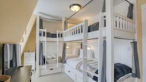 A multi-level bunk bed room with white railings, a small white dresser, and a ceiling light fixture. - Arcade, Family + Dog Friendly, Seabrook Town Center Home, 5min. walk to beach (Pacific Beach)