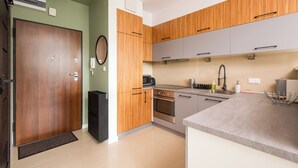 A modern kitchen with wooden cabinets, a built-in oven, and a sink.