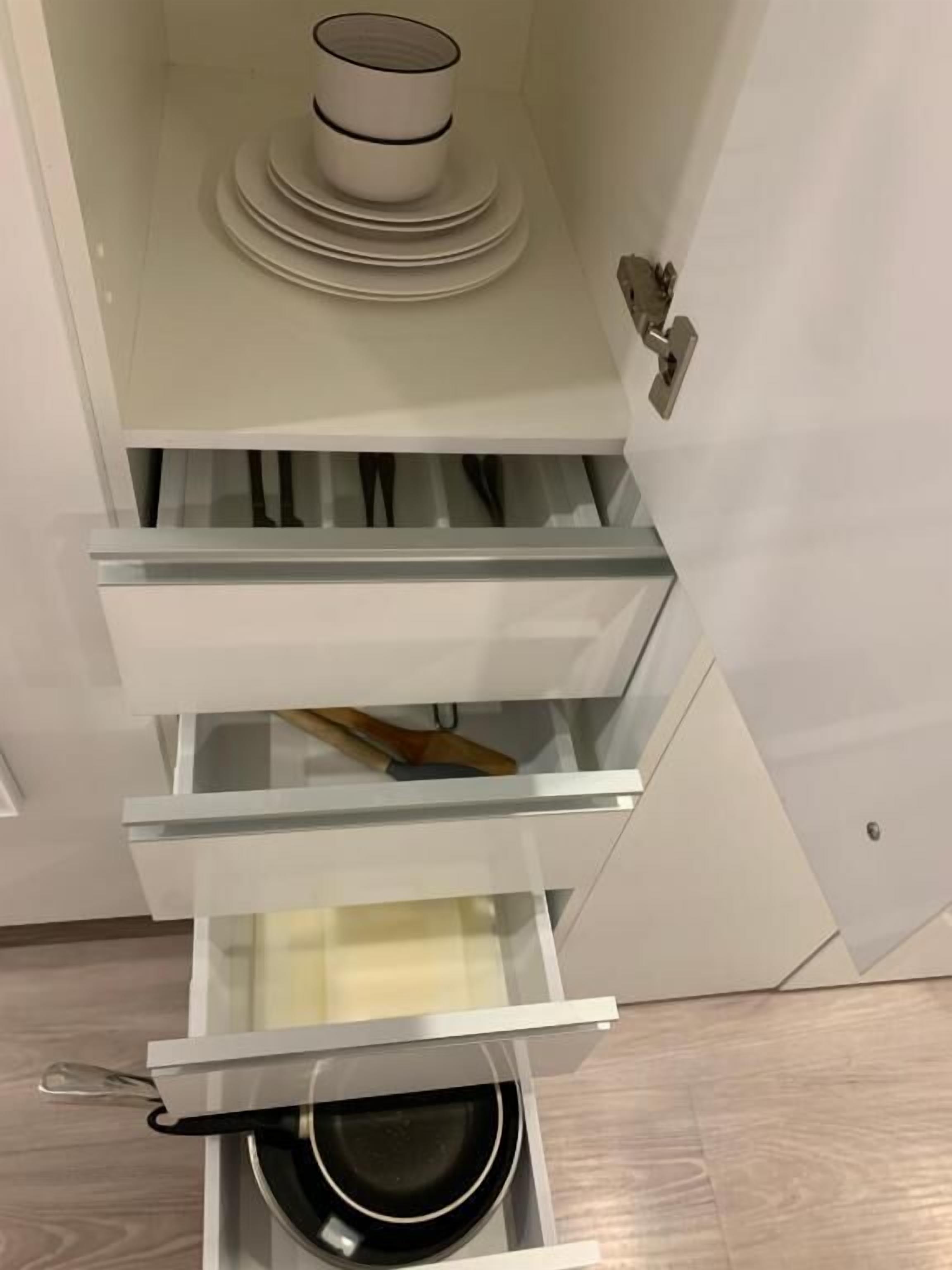 A modern kitchen with a built-in oven, a microwave, and a stove.