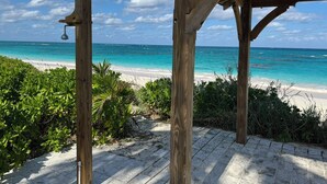 A wooden structure with a view of a beach and ocean.