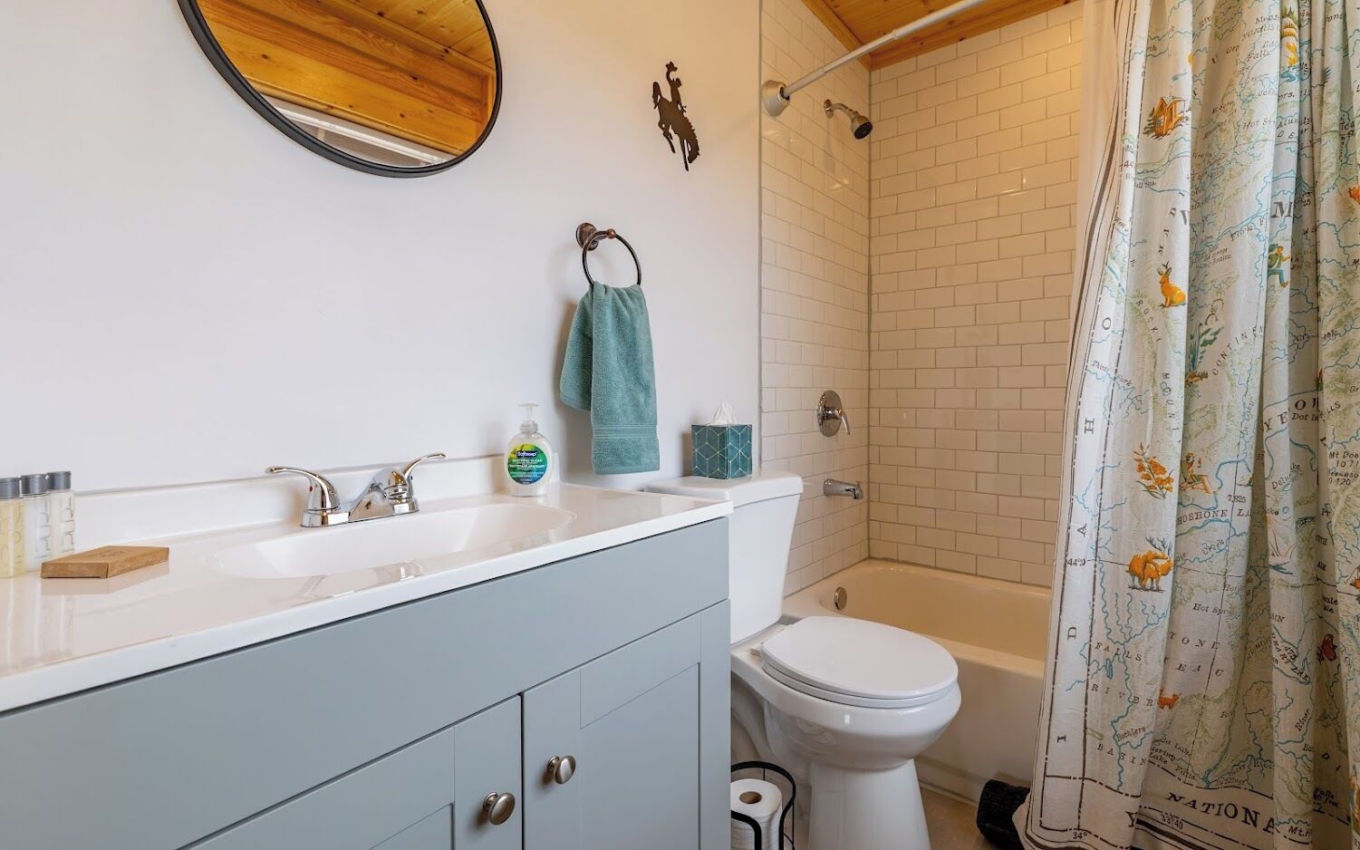 A bathroom with a white sink, a toilet, and a shower.