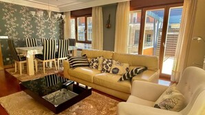 A living room with a sofa, armchair, coffee table, and dining set. - Katorse, 2 bedrooms, 2 bathrooms and elevator (Bermeo)