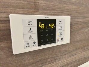 A Noritz thermostat with temperature settings and control buttons. - Seaside Condo  Nagisa House (Chatan)