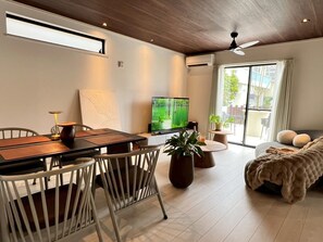 House | Living area | 65-inch Smart TV with digital channels - Seaside Condo  Nagisa House (Chatan)