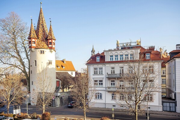 A historic tower with a tower and a building with multiple windows and balconies.