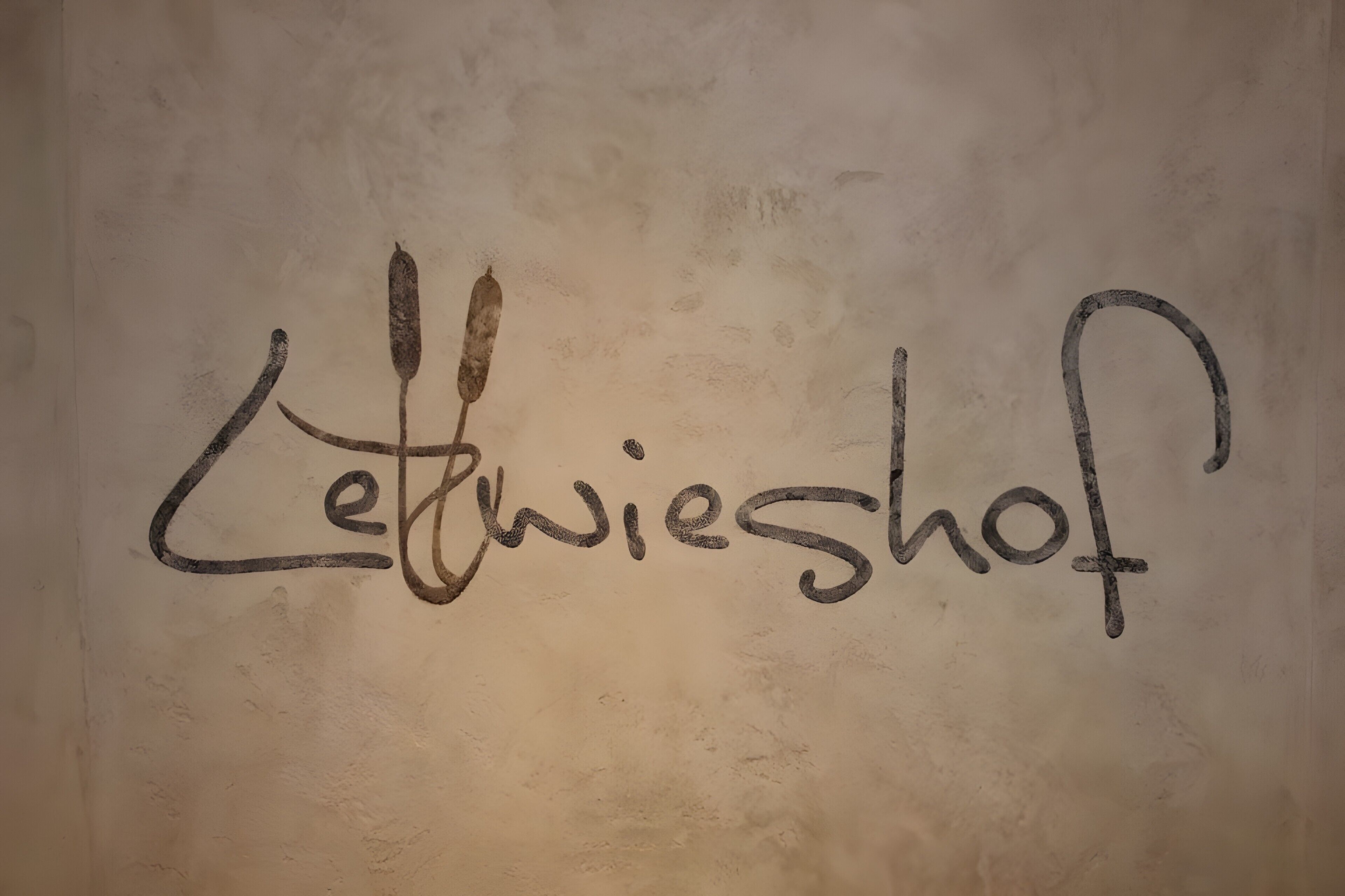 A wall with the text 'Letwieshof?' written in a stylized font.