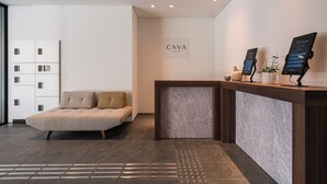 A modern reception area with a sofa, a reception desk, and a sign that reads "CAVA HOUSE".