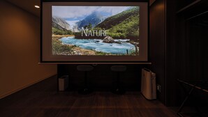 A projection screen displaying a nature scene with the word "NATURE" and a mountain landscape.