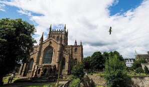 A historic church with a prominent tower and large windows.