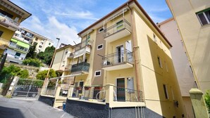 A multi-story residential building with balconies, a gated entrance, and a clear sky. - Comfort and Relax in the Heart of Imperia | Ap44 (Imperia)