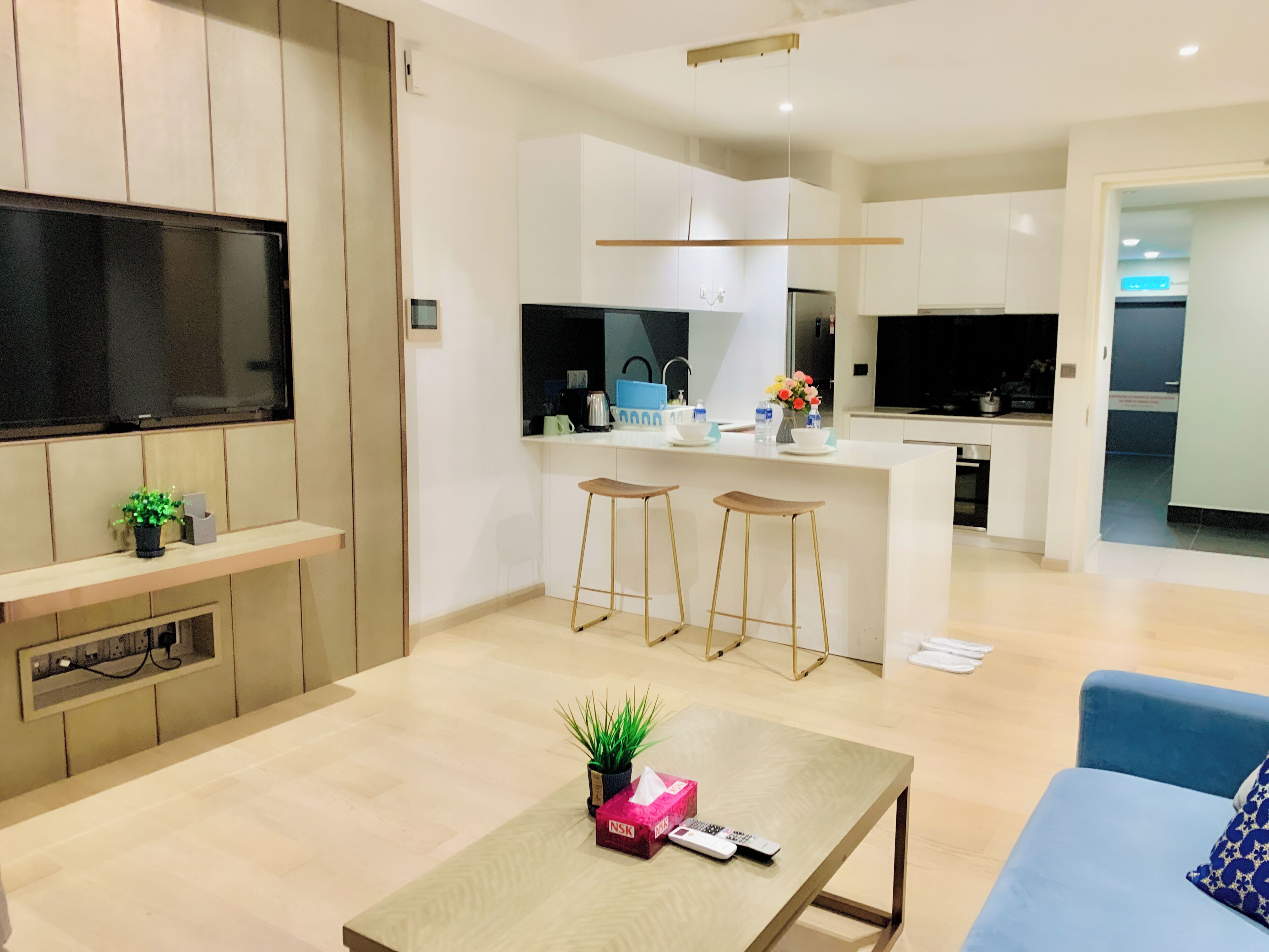 A modern apartment with a living room, kitchen, and dining area.