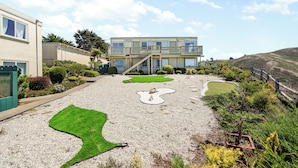 A modern building with a flat roof, multiple windows, and a balcony. - Charming 2BR Coastal Getaway in Pacifica (Pacifica)