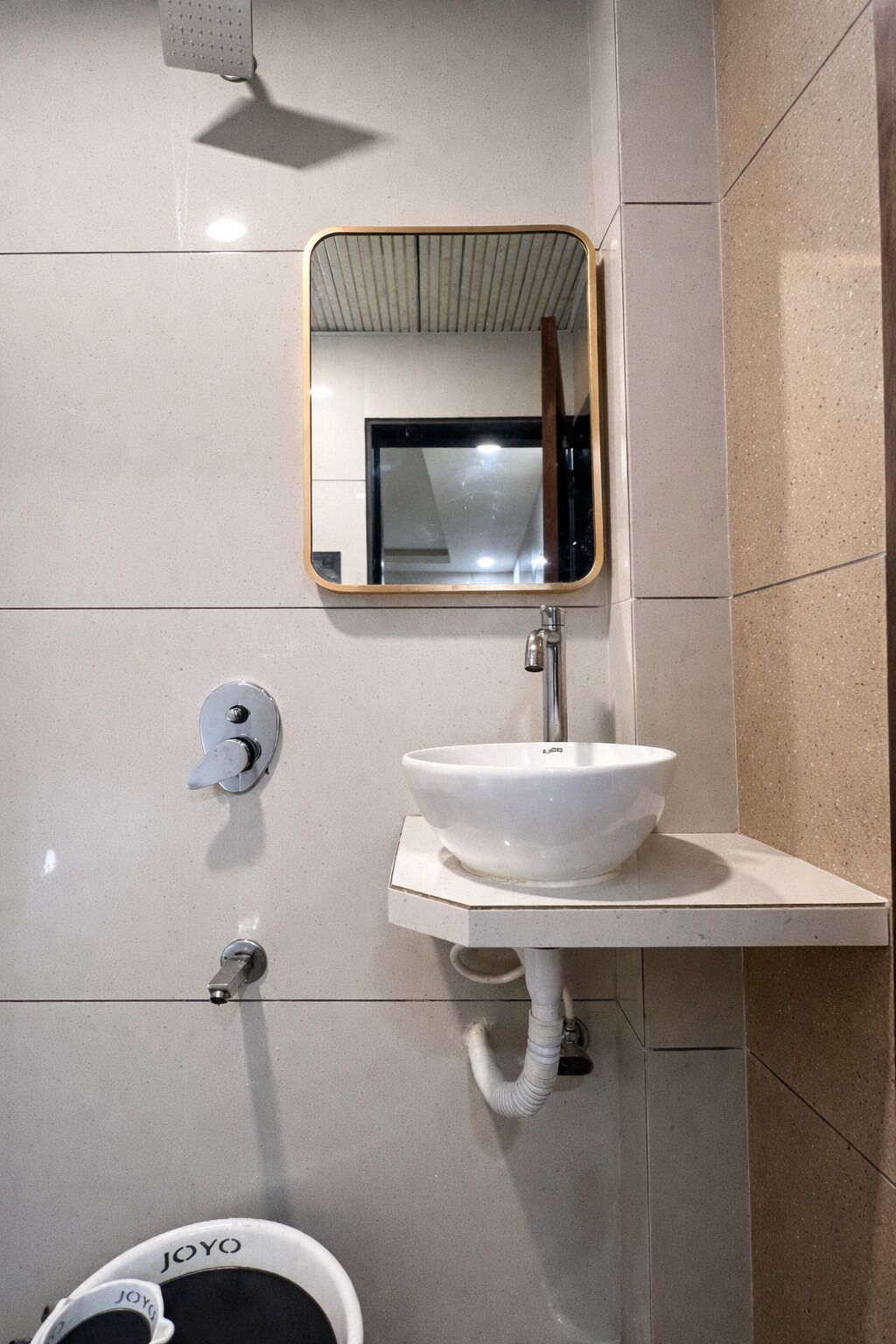 A bathroom with a white sink, a mirror, and a toilet.