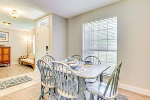 Enjoy meals with family and friends at the dining table, surrounded by comfortable seating for four.