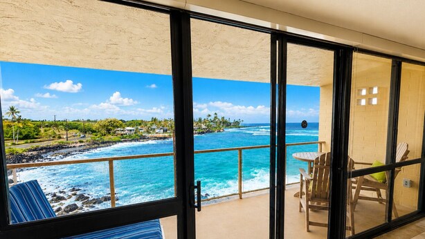A balcony with a view of the ocean and a tropical landscape. - Renee's Poipu Paradise! Oceanfront Views & A/C! (Koloa)