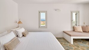 A bedroom with a large bed, a bench, and two windows offering a view of the landscape. - Villa Inke - Secluded Luxury (Kostos)