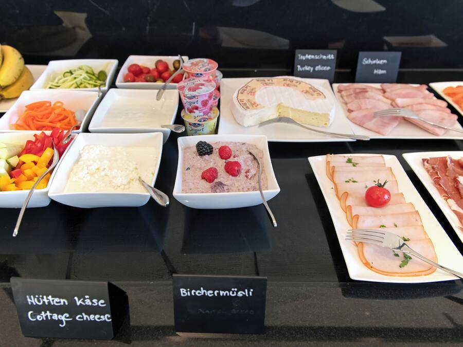 A buffet with various food items including cottage cheese, yogurt, and smoked salmon.