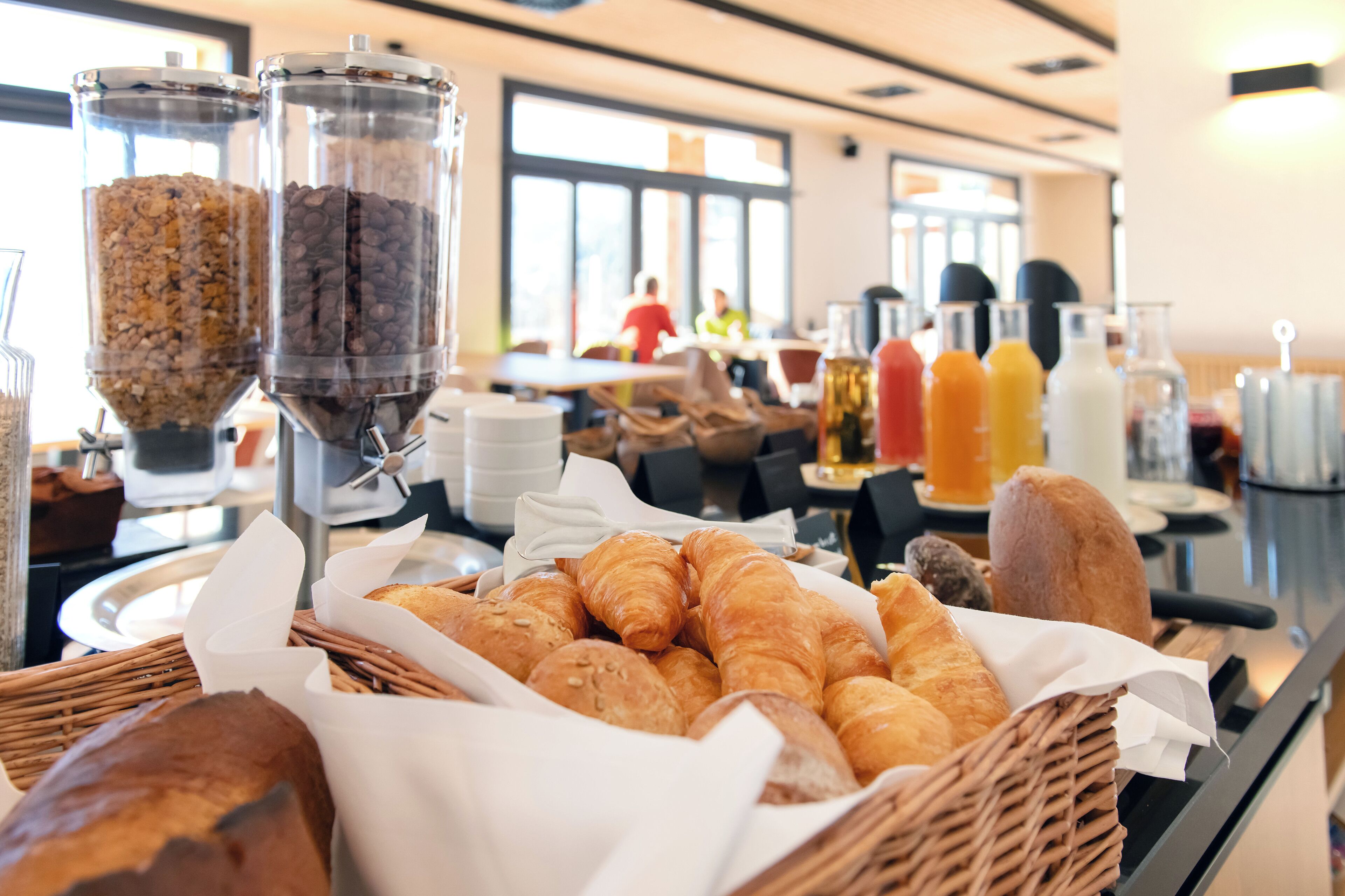 A breakfast buffet with various pastries and beverages.