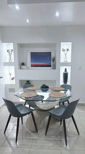 Dining for four with custom lit shelving adjacent to the kitchen - Isla Verde Beach Condo: 5-Min Walk to Beach, King Bed, Big Pool, Washer&Dryer (Carolina)