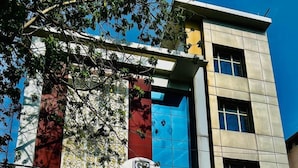 A hotel with a modern facade, featuring a prominent sign for the Grand Pinnacle Hotel. - Grand Pinnacle Lucknow (Lucknow)