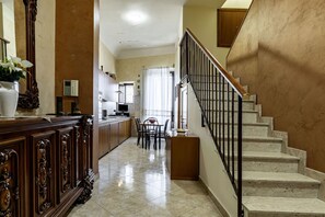 A kitchen with a dining area, a staircase, and a living room. - GuestHost - Center Apartment Catania (Catania)